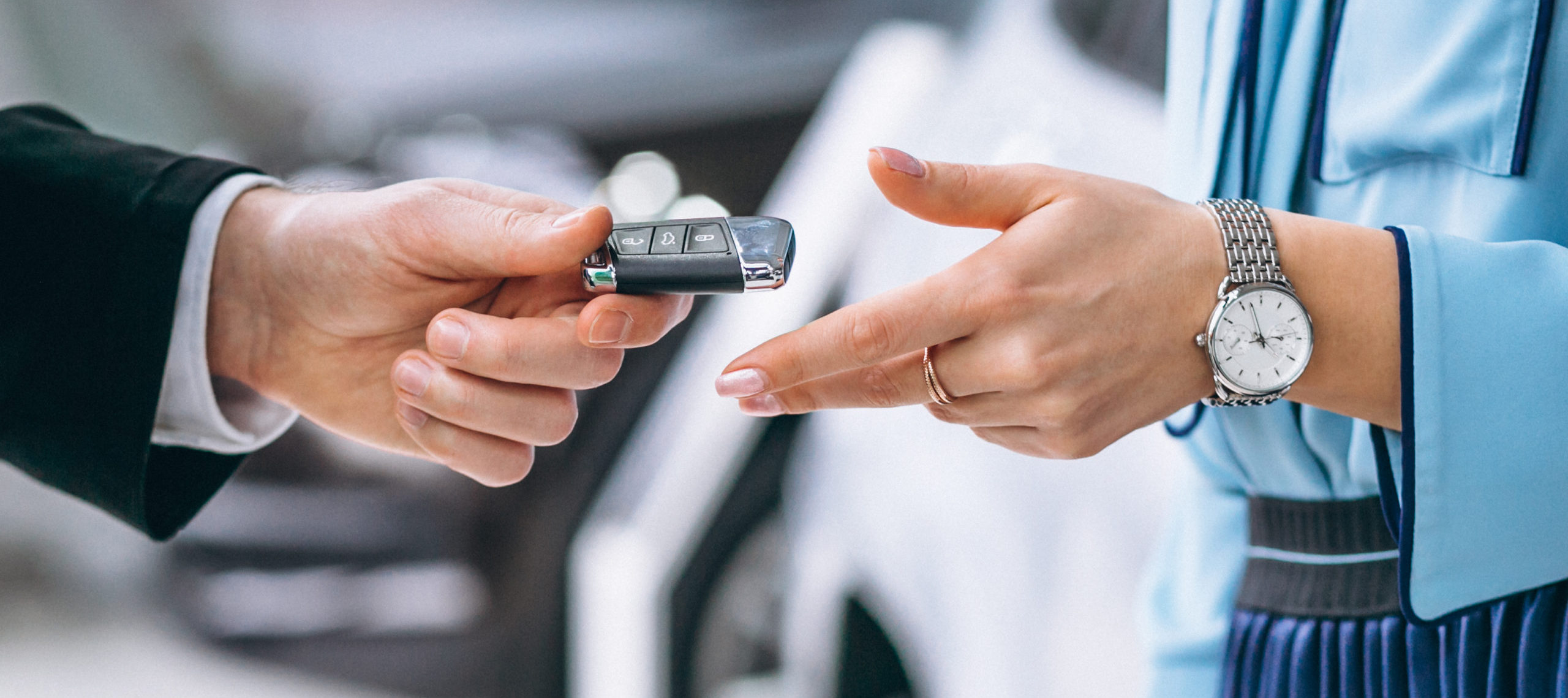 Close-up of hands passing car keys