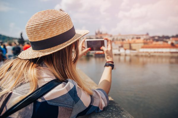 Young woman happy with backpack tourist taking selfie photo came Young woman happy with backpack tourist taking selfie photo camera on Charles Bridge in Prague, Czech Republic. Concept travel.